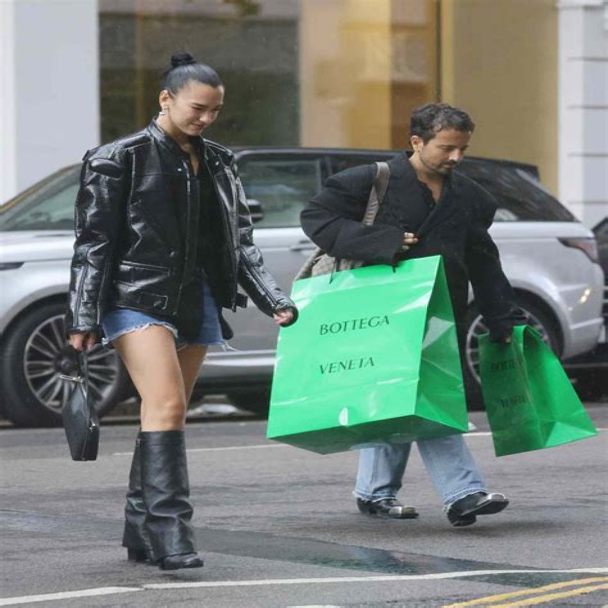 Dua Lipa Played With Proportions in an Oversized Moto Jacket, Tiny Shorts, and Knee-High Boots